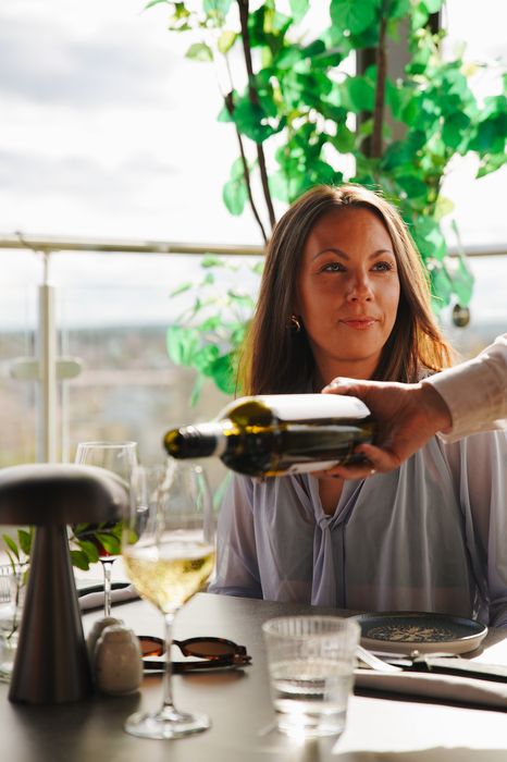 Vin serveras på takterrassen en sommarkväll